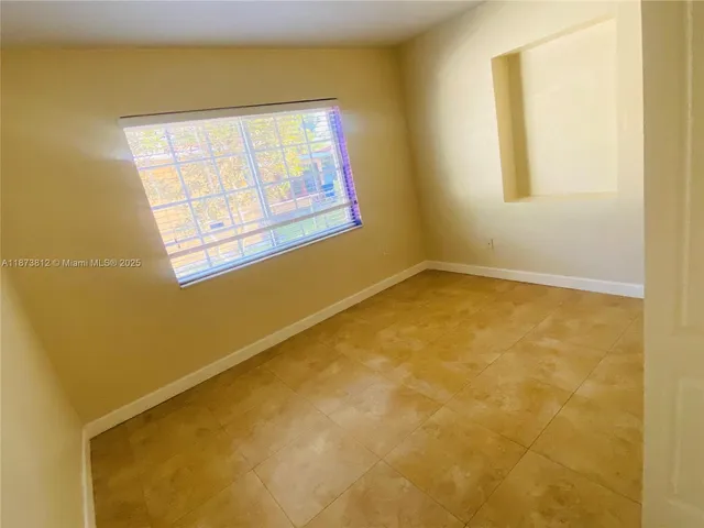 a view of a room with wooden floor and a cabinet