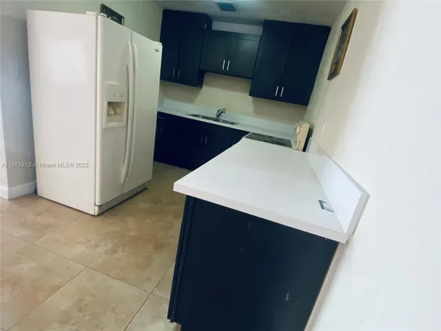 a kitchen with stainless steel appliances a refrigerator and a sink