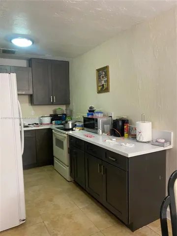 a kitchen with stainless steel appliances granite countertop a sink dishwasher stove and refrigerator