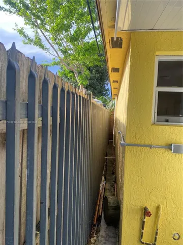 a view of a patio with a table and chairs under an umbrella