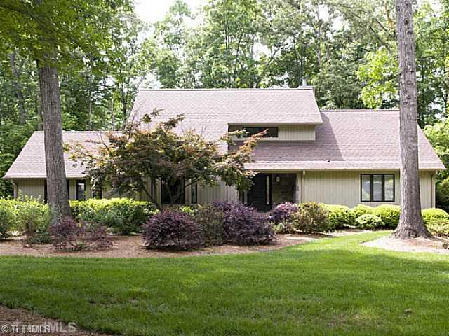 4102 Rockingham Road South Greensboro, NC 27407 - Photo 1 of 16 Exterior Front. Beautiful landscaping welcomes you to this Sedgefield contemporary.