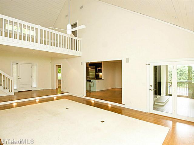 4102 Rockingham Road South Greensboro, NC 27407 - Photo 16 of 16 Living Room. Open floor plan w/access points from living room to kitchen, dining, master, & screened porch.