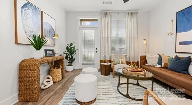 a living room with furniture and a potted plant