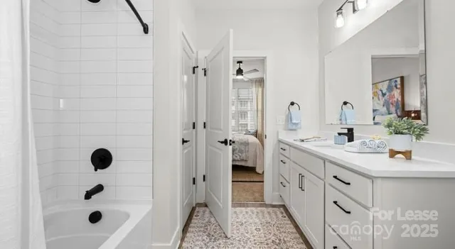 a bathroom with a tub sink shower and mirror