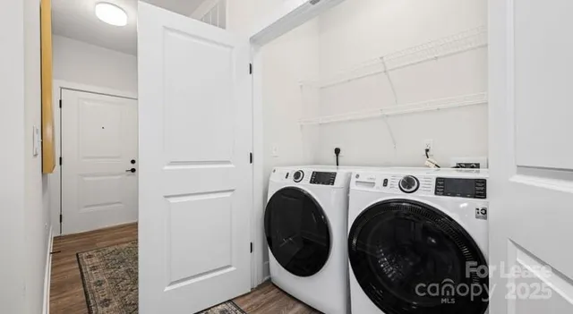 a view of a storage & utility room with dryer and washer