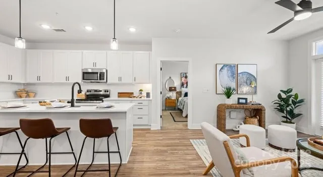 a kitchen with cabinets and wooden floor