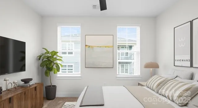 a bedroom with a bed potted plant with the window