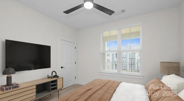 a bedroom with a bed and a flat screen tv