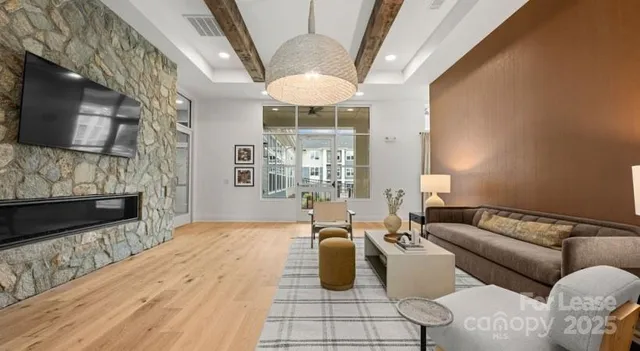 a living room with furniture a fireplace and a flat screen tv