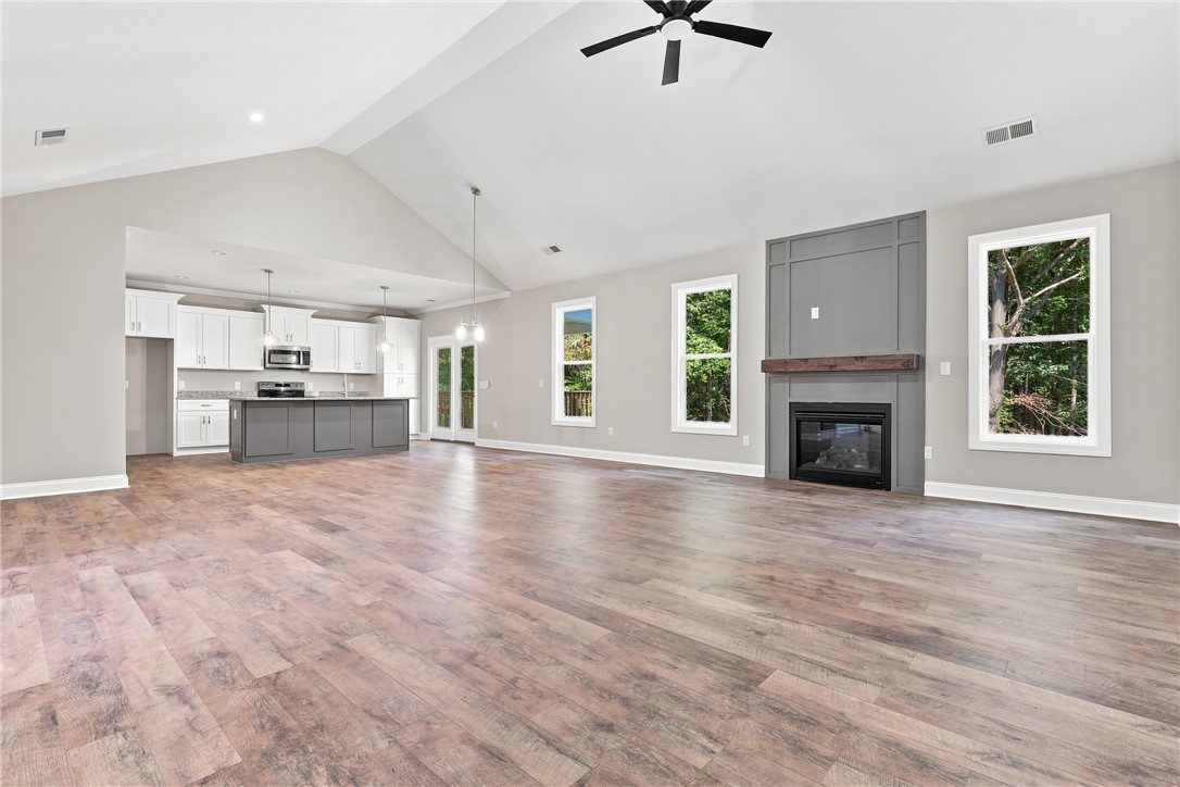 216 West Halfway Branch Road Walhalla, SC 29691 - Photo 8 of 41 Gleaming hardwood floors and a towering vaulted ceiling anchor this spacious, light-filled great room.