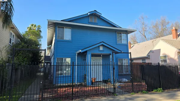 a front view of a house with wooden fence