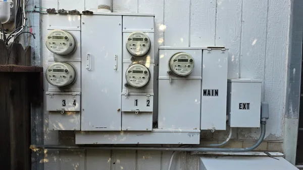 a clock on a wall next to a kitchen