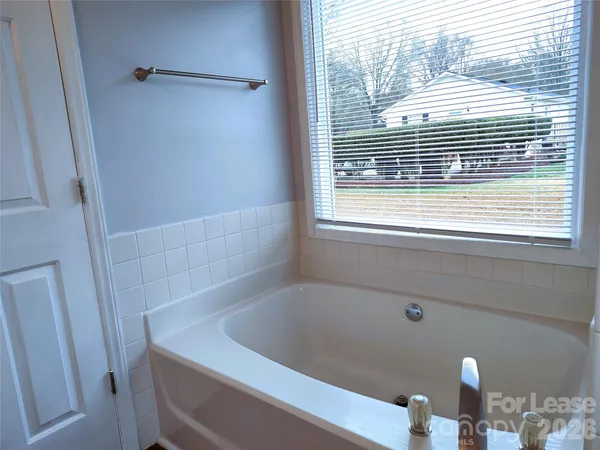 a bathroom with a window and a shower