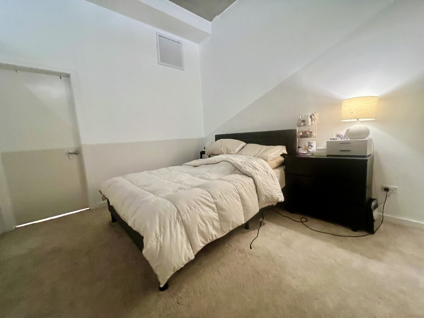 1151 West 15th Street, Unit 137 Chicago, IL 60608 - Photo 14 of 27 a bed sitting in a bedroom next to a lamp
