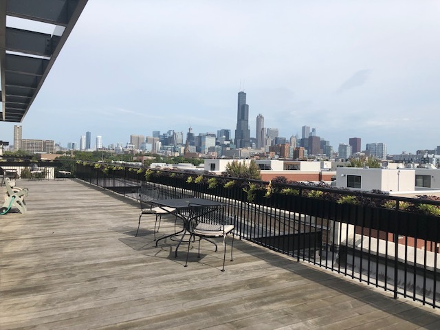 1151 West 15th Street, Unit 137 Chicago, IL 60608 - Photo 27 of 27 a view of a terrace with wooden benches