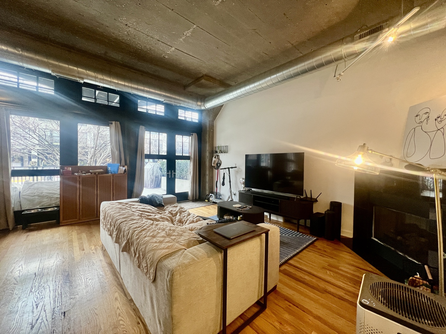 1151 West 15th Street, Unit 137 Chicago, IL 60608 - Photo 3 of 27 a bed room with furniture and a flat screen tv
