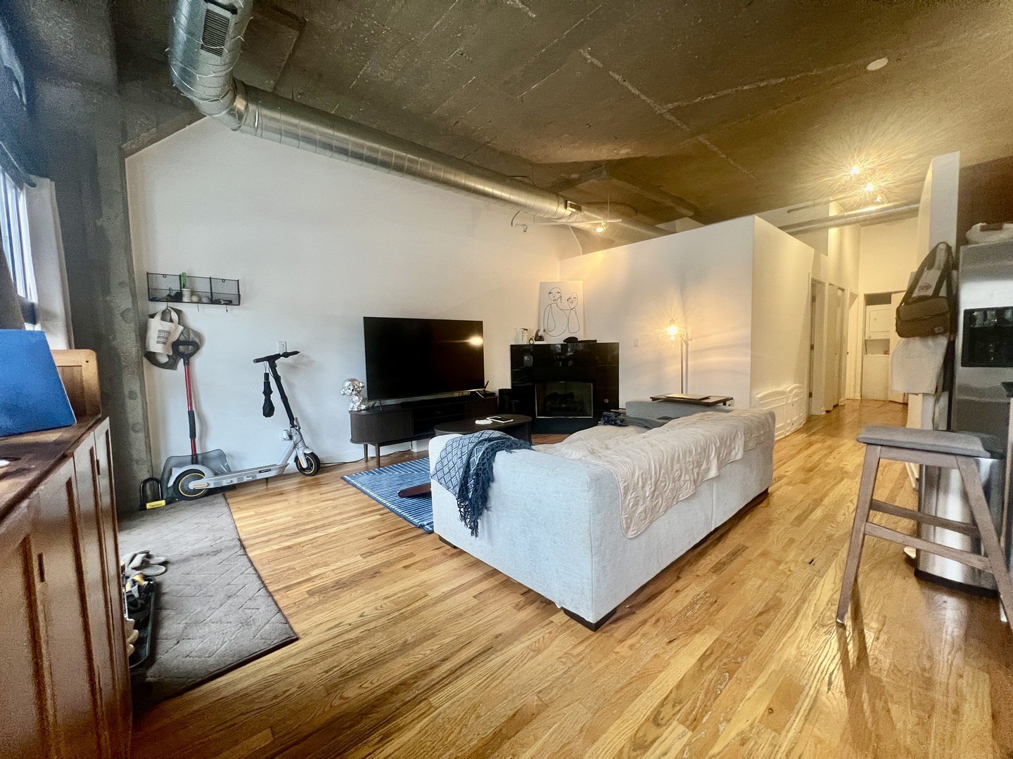 1151 West 15th Street, Unit 137 Chicago, IL 60608 - Photo 5 of 27 a living room with furniture and a flat screen tv