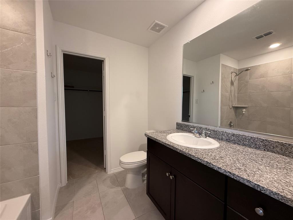 5970 Wedgemere Drive Princeton, TX 75407 - Photo 14 of 17 a bathroom with a granite countertop sink and a mirror