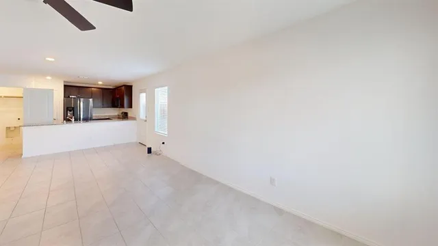 a view of a kitchen with a sink and a refrigerator