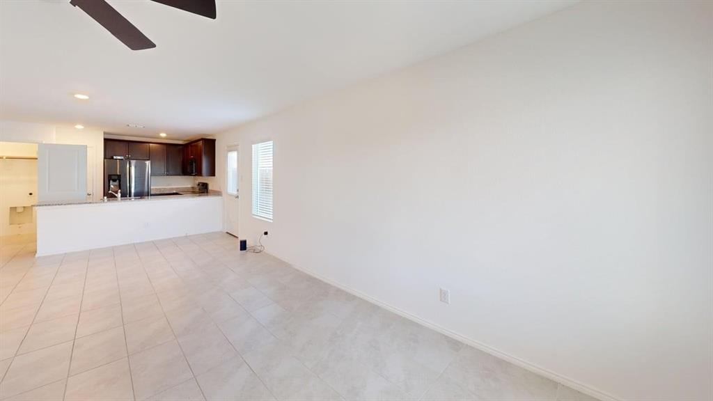 5970 Wedgemere Drive Princeton, TX 75407 - Photo 3 of 17 a view of a kitchen with a sink and a refrigerator