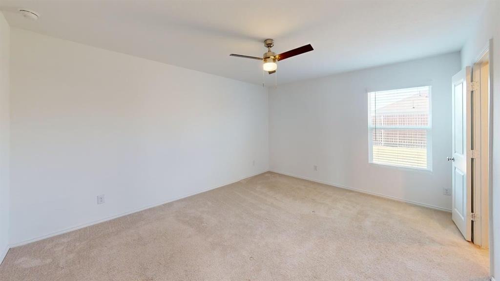5970 Wedgemere Drive Princeton, TX 75407 - Photo 7 of 17 an empty room with a window and a fan