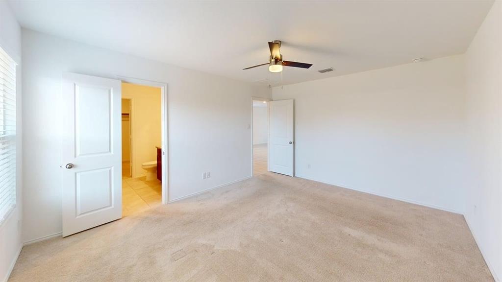 5970 Wedgemere Drive Princeton, TX 75407 - Photo 9 of 17 an empty room with a ceiling fan and a window