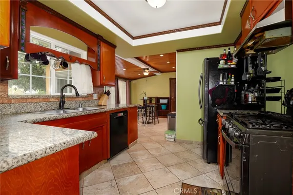 a kitchen with stainless steel appliances granite countertop a sink and a counter