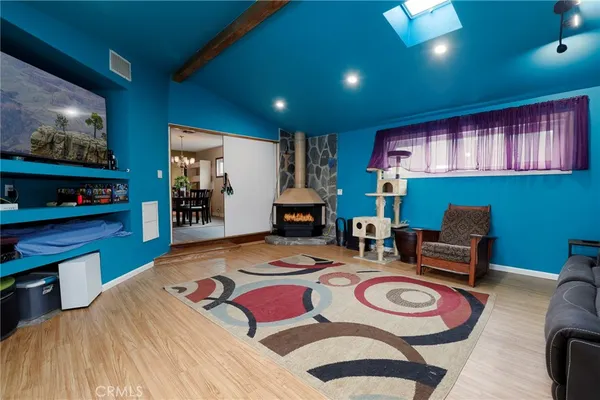 a dining room with furniture and a flat screen tv
