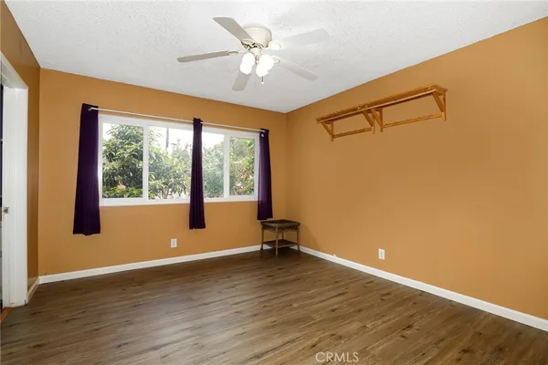 a view of a room with wooden floor and a window
