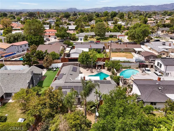 an aerial view of a houses with a swimming pool