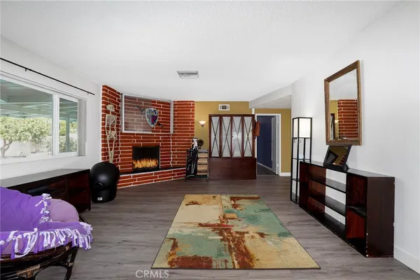 a living room with furniture rug and wooden floor