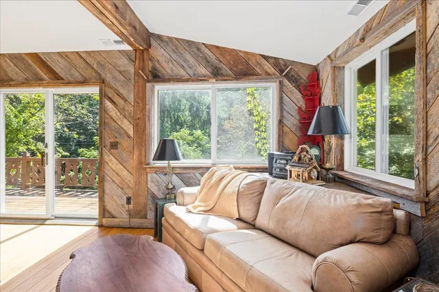 a view of living room with furniture and a fireplace