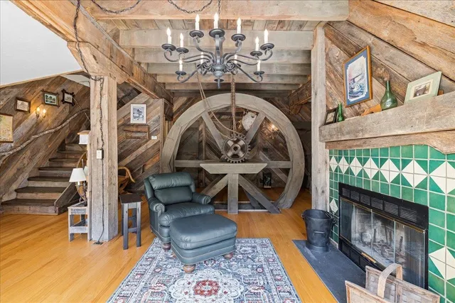 a front view of a building with a garden and seating area