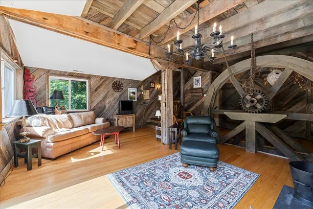 a dining room with furniture a window and wooden floor