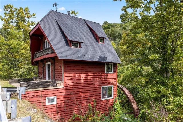 a aerial view of a house with a yard and balcony
