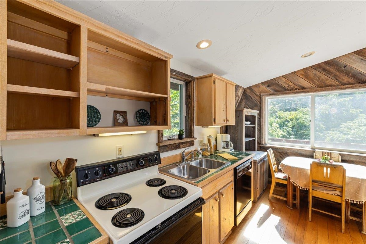 6602 Middlebrook Road Raphine, VA 24472 - Photo 32 of 68 a kitchen with a stove a refrigerator and a dining table
