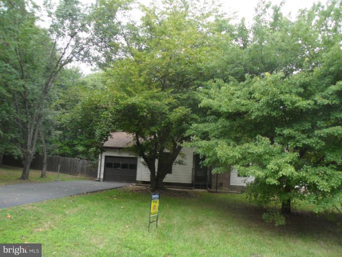 137 Choptank Road Stafford, VA 22556 - Photo 5 of 9 a front view of a house with a garden
