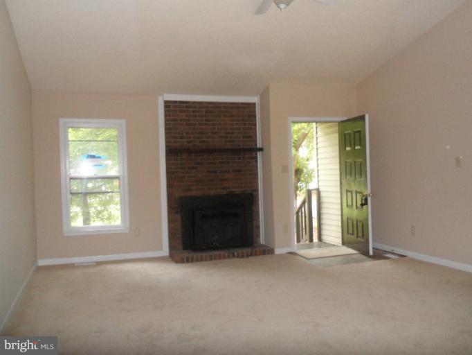 137 Choptank Road Stafford, VA 22556 - Photo 7 of 9 an empty room with windows and fireplace