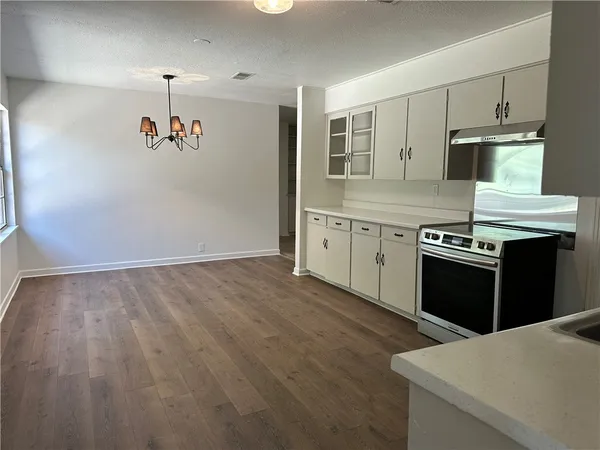 a kitchen with granite countertop a stove and a refrigerator