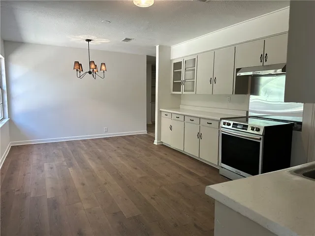 a kitchen with granite countertop a stove and a refrigerator