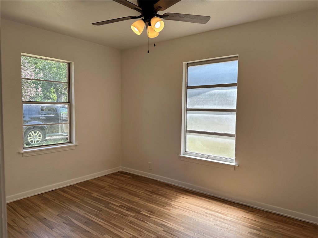 4814 Jean Street Corpus Christi, TX 78411 - Photo 7 of 11 a view of an empty room with wooden floor and a window