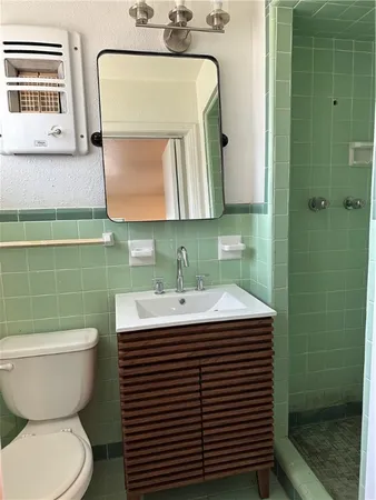 a bathroom with a sink toilet and mirror
