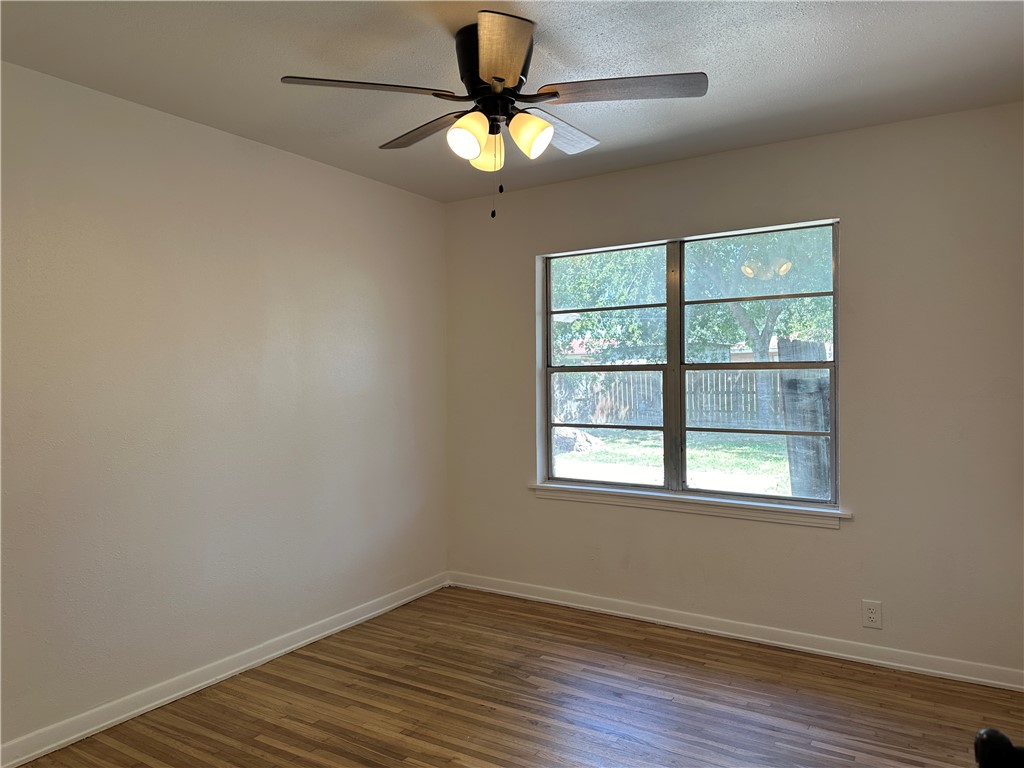 4814 Jean Street Corpus Christi, TX 78411 - Photo 10 of 11 wooden floor in an empty room with a window