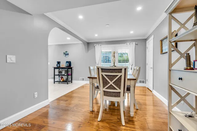 a dining room with furniture and wooden floor