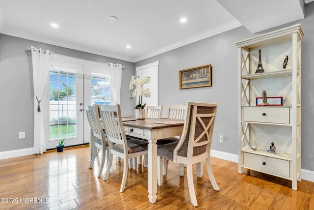 a view of a dining room with furniture a kitchen and chandelier