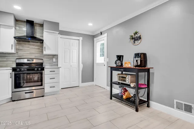 a view of a kitchen with fridge and workspace