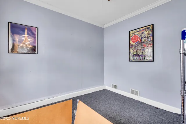 a view of a room with painting on the wall