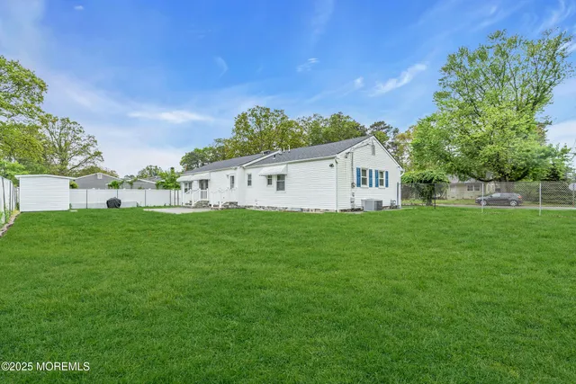 a view of house with backyard