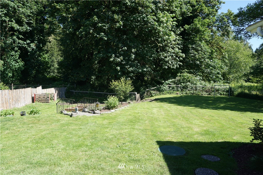 1507 South Machias Road Snohomish, WA 98290 - Photo 5 of 22 a view of a bench in the garden