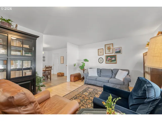 a living room with furniture a rug and a window
